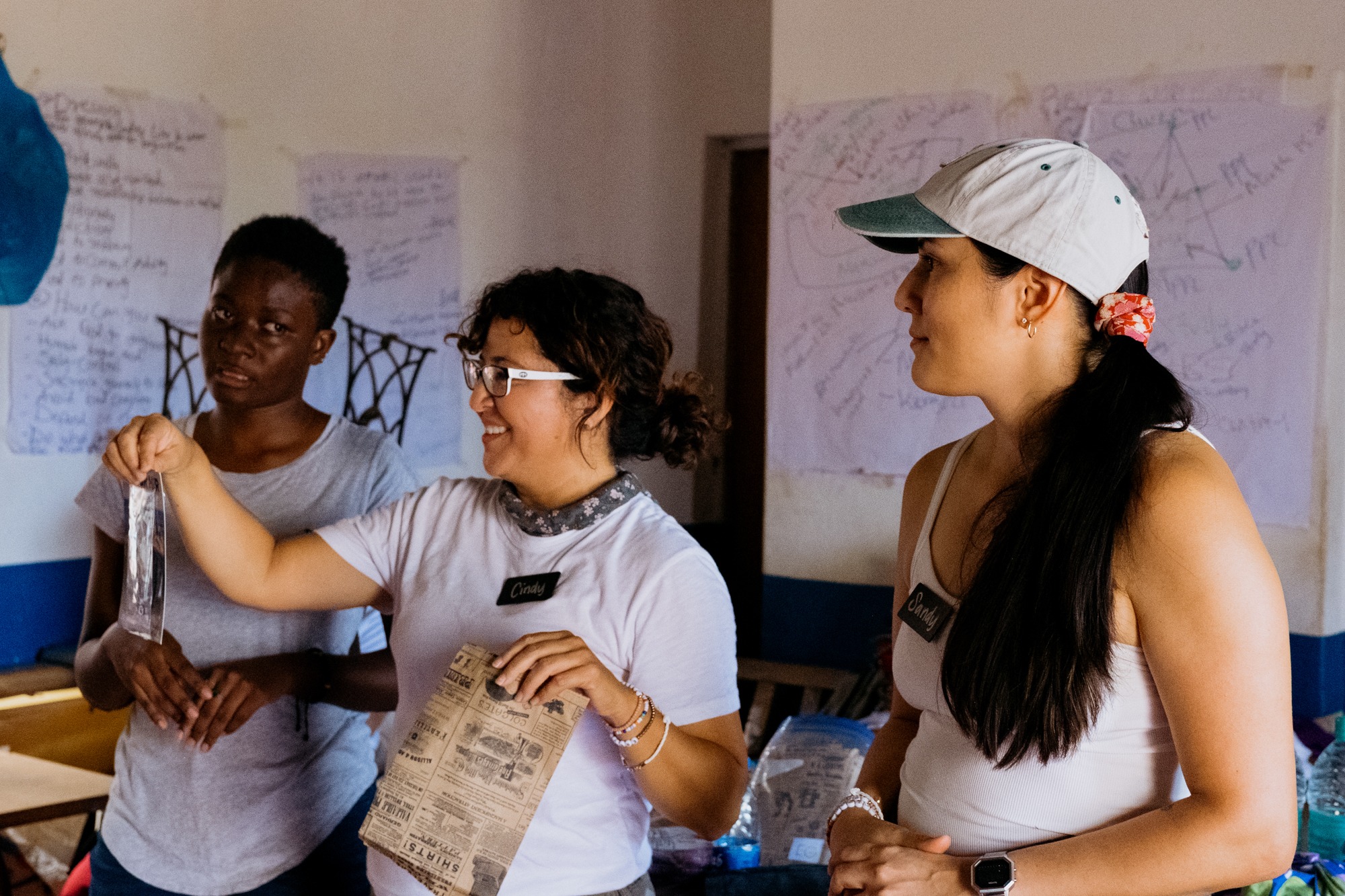 Cindy and Sandy explaining a workshop while Esther (an Elimu intern) tries her best at an impromptu translation from English to Swahili at Heri Sewing College