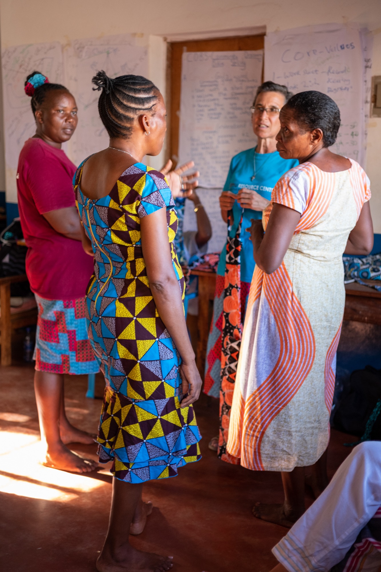 Wambui, Madame Grace, Madame Nina, and Madame Lynne discussing logistics in the classroom